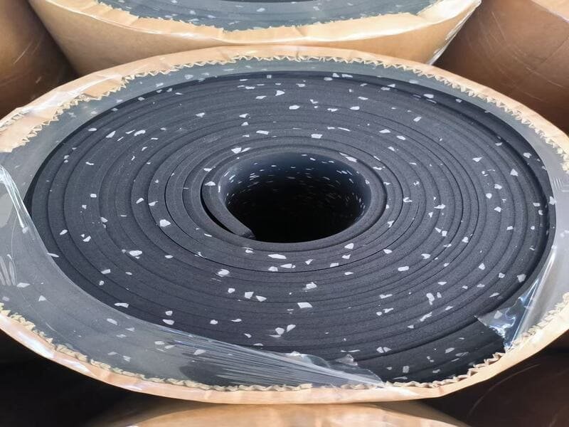 A micrometer measuring the precise thickness of a rubber flooring sample